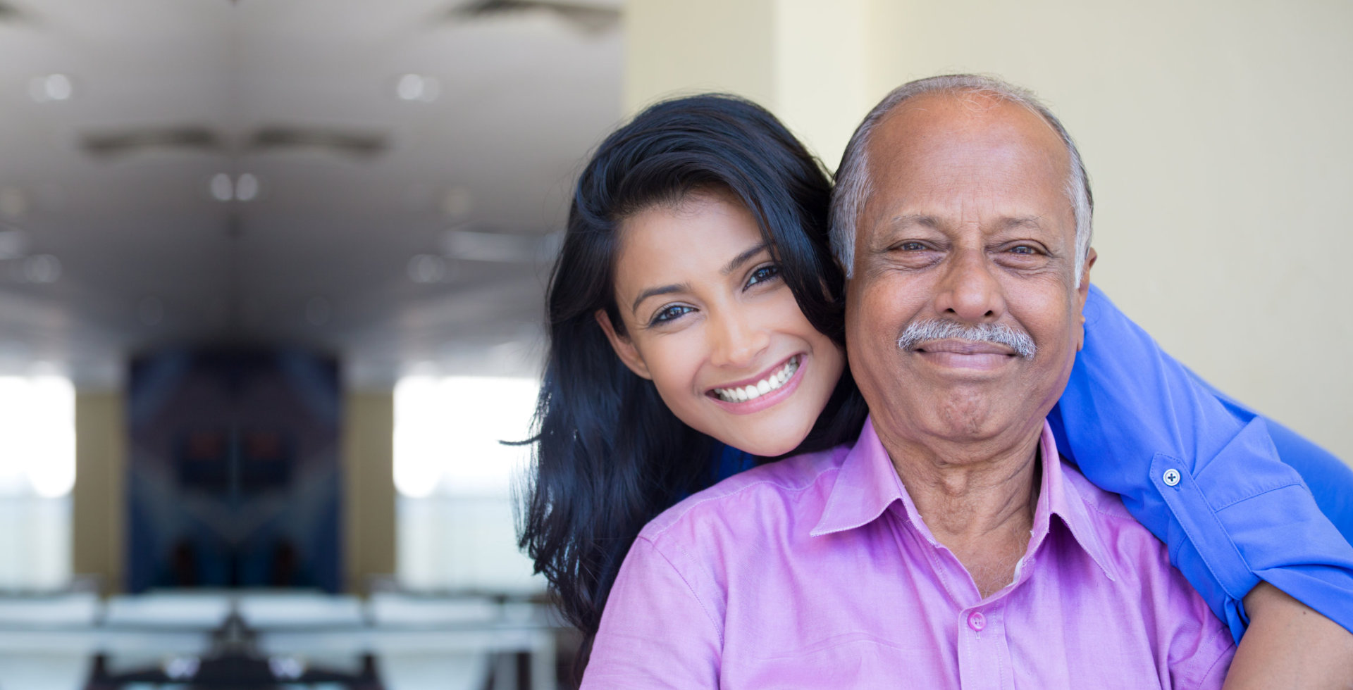 caregiver and senior man smiling