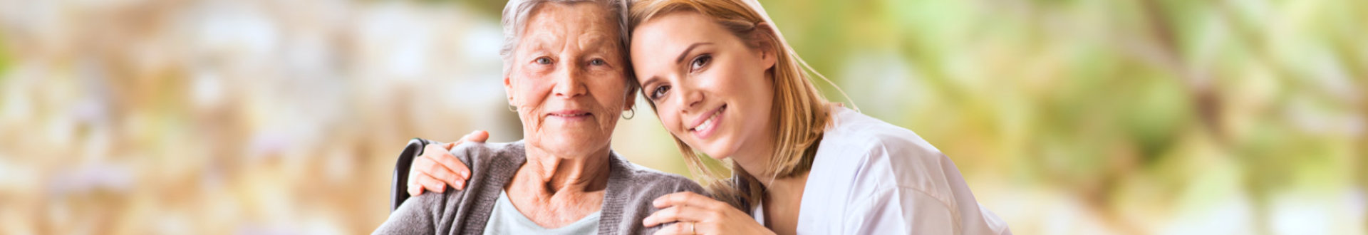 caregiver and senior woman smiling