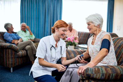 nurse taking care of pensioner in the retirement house