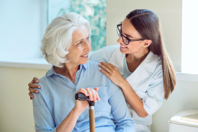 smiling senior woman with her home caregiver